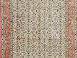 an antique persian rug with a red border and a white background