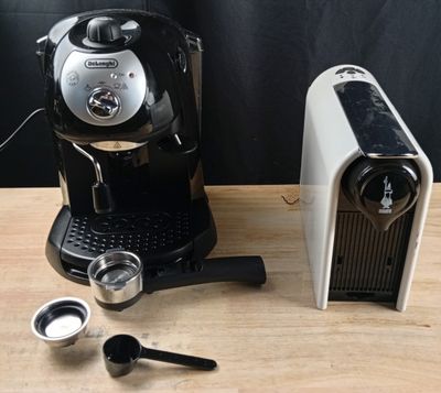 an image of a coffee maker and a cup of coffee on a table