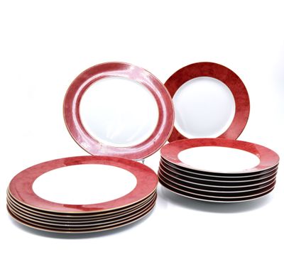 several red and white plates are stacked on top of each other