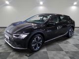 a black car parked in a room with a checkered floor