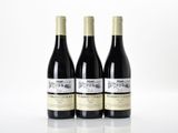 three bottles of wine sitting on top of a table next to each other