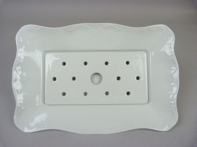 a picture of a white plate with holes in it
