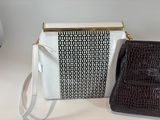 two purses sitting next to each other on a table
