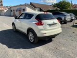 the back of a white car parked in a parking lot