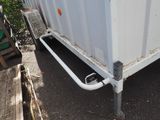 an image of a white trailer parked on the side of the road