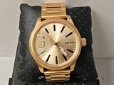 michael korsch watch in gold with black dial and gold bracelet
