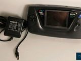 an image of a game console with a charger and power supply