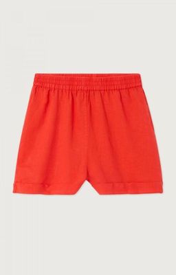 a baby boy ' s red shorts with a white logo on the side