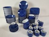 a lot of blue and white dishes and cups on the table