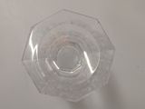 a clear glass with a hole in it on a table