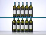 several bottles of wine sit on a shelf in front of a glass shelf