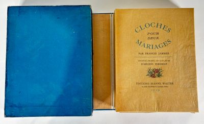 an old book in a blue case sitting on top of a white table