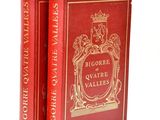 two red books sitting on top of each other on a white surface