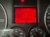 a close up of a car dashboard with a red light