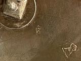a silver plate with a clock on it on a table