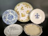 three plates with blue and white designs are sitting on a table