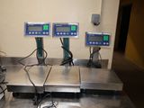 three electronic scales sitting on top of a metal counter