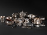 a lot of silverware on a black table