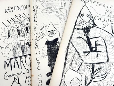 three books with drawings on them on a table