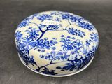 a close up of a small blue and white box on a table