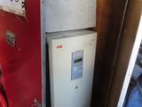 a small refrigerator inside of a red box with a sign on it
