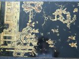 a picture of a black and gold painting on the wall