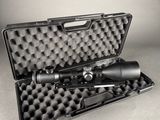 an open case with a rifle and a scope on a table