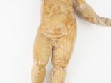 a small wooden statue of a baby holding a frisbee