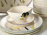 a lot of plates and bowls on the table