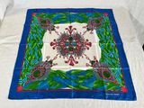 blue and green square scarf with red flowers and leaves
