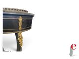 a black and gold table with a clock on top of it