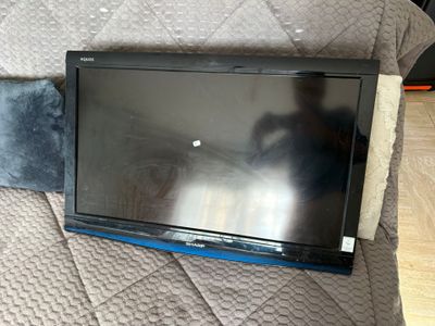 a flat screen tv sitting on top of a couch