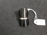 a ring that is sitting on a table next to a tag