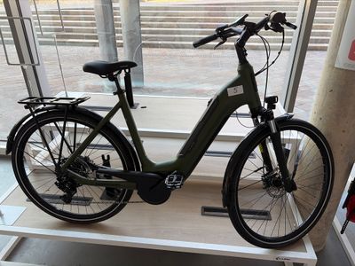 un vélo posé sur une étagère devant une fenêtre