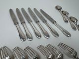 a lot of forks and spoons that are on the table