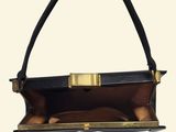 a black and gold handbag with a handle on a white background
