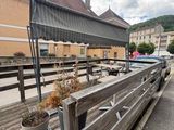 a wooden bench on the side of a building