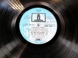 an old record with a label on it sitting on top of a table