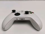 a close up of a white controller on a table