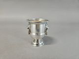 a silver cup that is sitting on a table