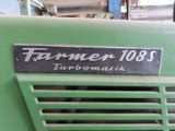 a close up of a green tractor with a sign on the front of it