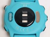 a close up of a wrist watch with a blue band