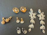 a bunch of jewelry sitting on top of a black surface