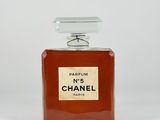 a bottle of chanel perfume sitting on top of a white surface