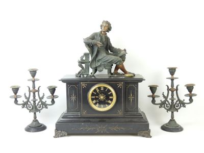 a statue of a man sitting on a table next to a clock