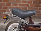 a motorcycle that is parked in front of a brick wall