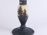 a black and white vase with trees on it