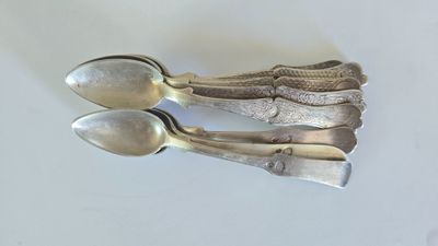 three spoons that are sitting on a table