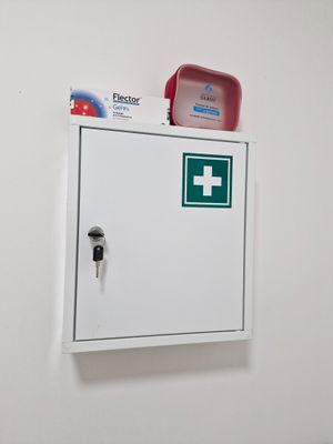 a white box with a green cross on top of it