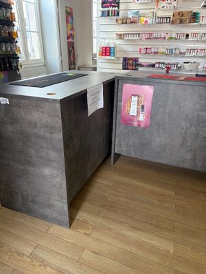 a counter in a store with a lot of items on the shelves